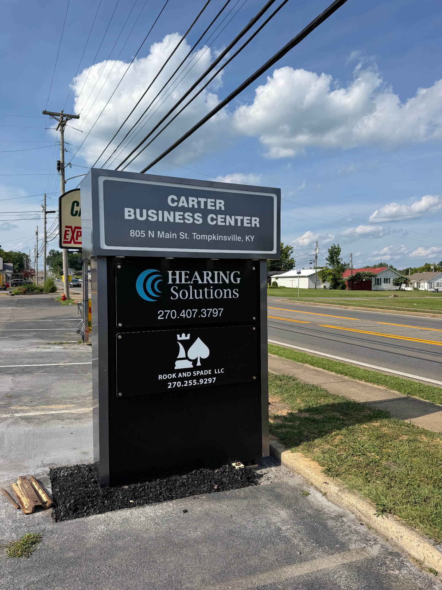 Pylon sign for Carter Business Center listing Hearing Solutions and Rook and Spade LLC