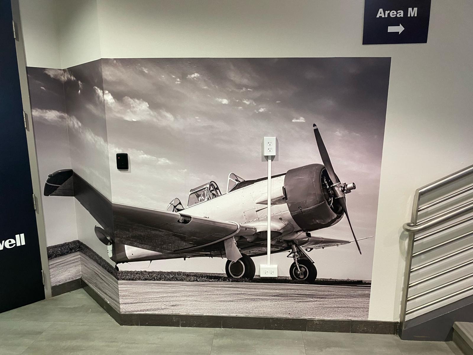 Black and white aircraft photo mural wrapping a stairwell wall